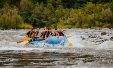 people riding on blue kayak on river during daytime