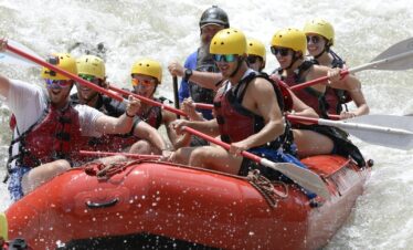 a group of people riding on top of a raft