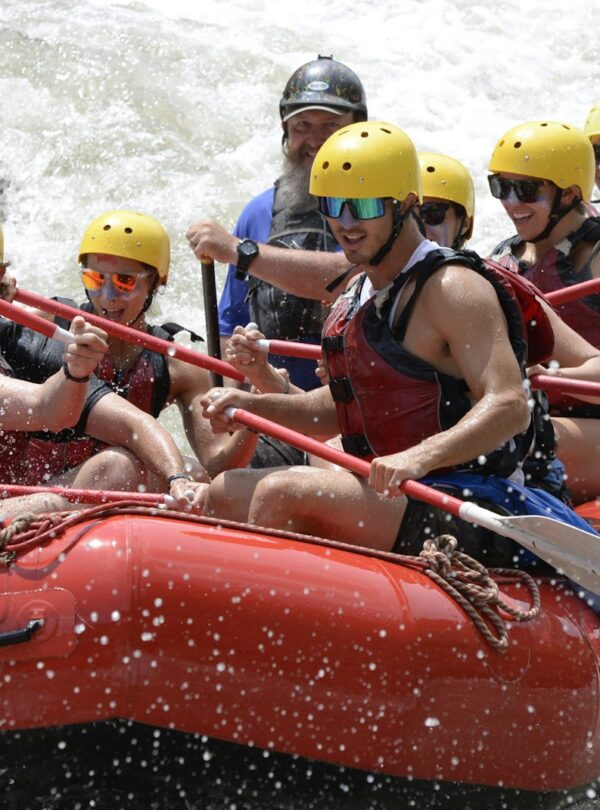 a group of people riding on top of a raft